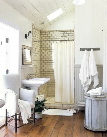 vitt badrum med trägolv