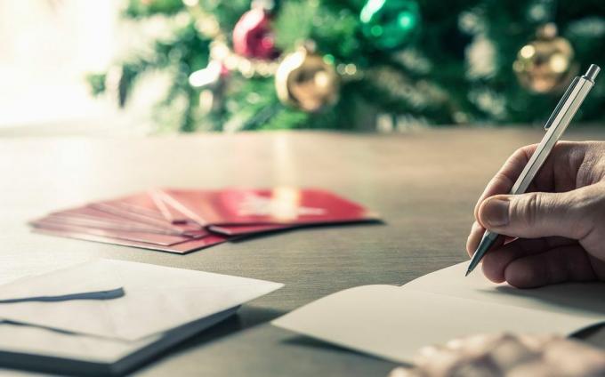 skriva julkort meddelanden framför ett semesterträd